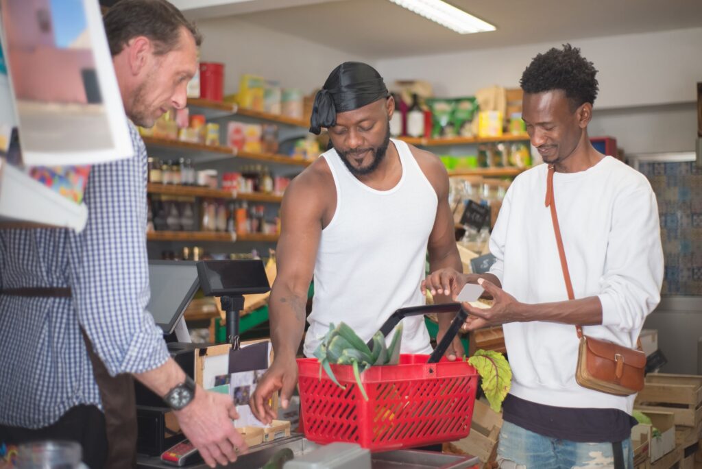 Cashier serving customers at a shop till