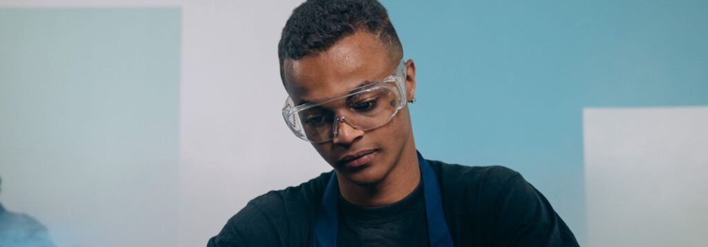 Young IT technician working on a computer motherboard