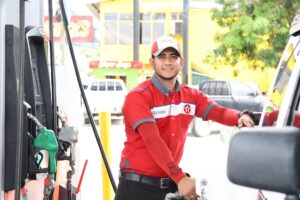 Smiling petrol attendant at fuel pump
