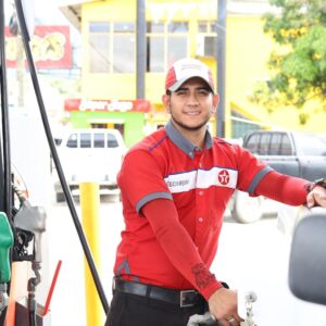 Smiling petrol attendant at fuel pump
