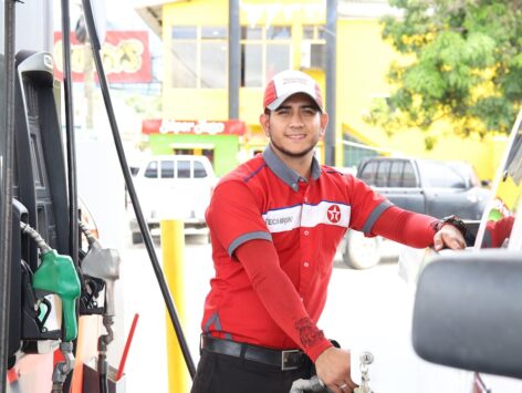 Smiling petrol attendant at fuel pump