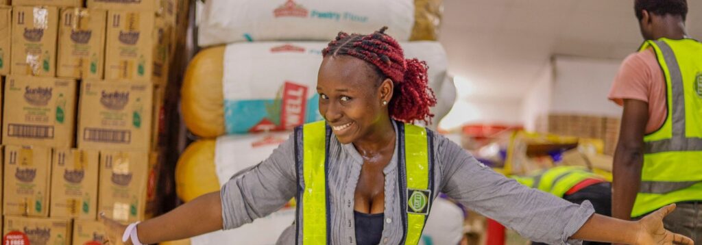 Smiling warehouse worker in a hi-vis vest in a distribution centre